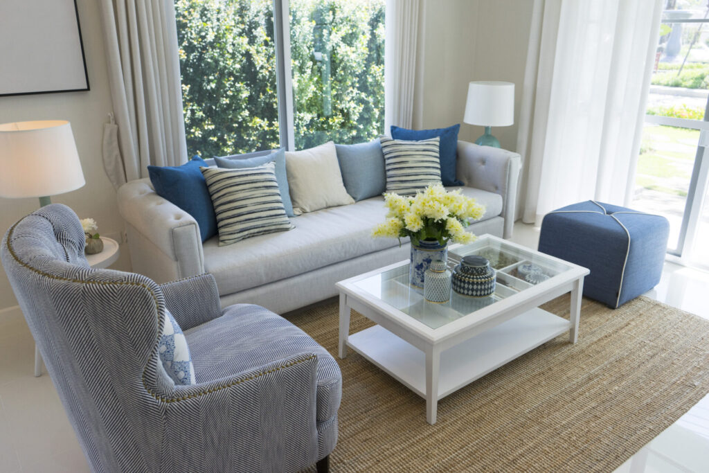 navy blue pillows and gray sofa by the window